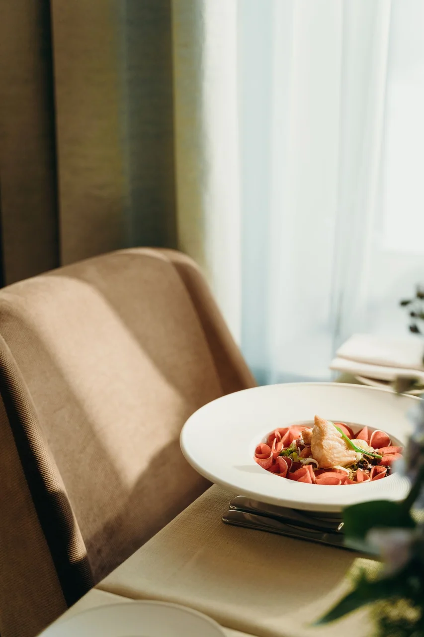 Gourmet dish illuminated by natural restaurant light